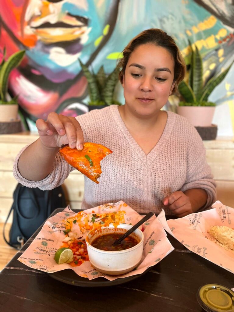 Decorative image of woman eating a taco.